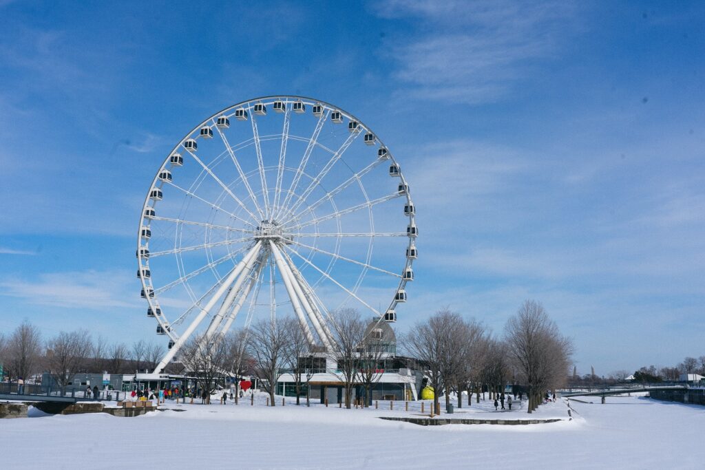 A breathtaking view of the Montreal Ferris wheel against the city skyline. The towering Ferris wheel stands as an iconic landmark, offering panoramic vistas of Montreal's vibrant cityscape.