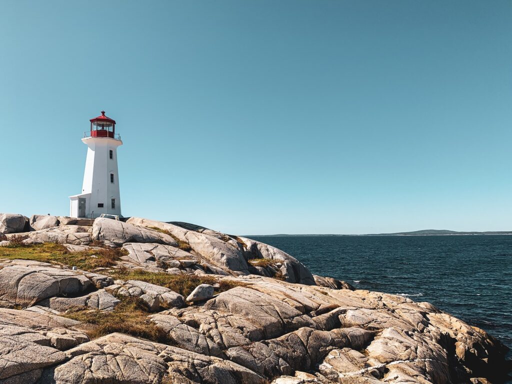 Captivating Nova Scotia lighthouse amidst dramatic coastal rocks, representing the synergy between nature's beauty and CBD wellness in Canada